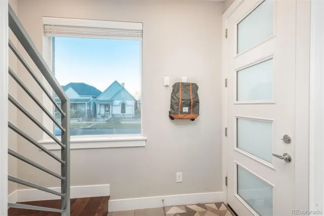 a view of staircase with white walls and a window