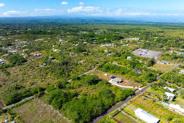 an aerial view of multiple houses with yard