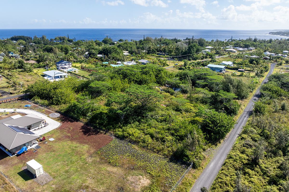 15-1576 Lot 3077 Beach Road Keaau, HI 96749 - Photo 15 of 23 an aerial view of multiple houses with yard