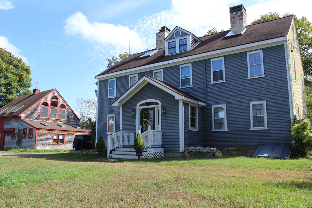 a front view of a house with a garden and yard
