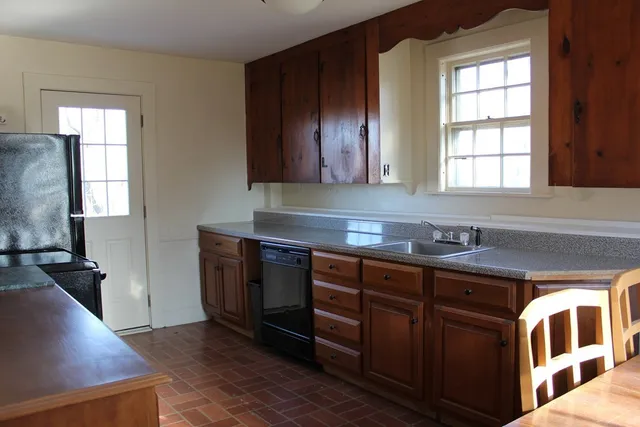 a kitchen with stainless steel appliances granite countertop a sink and a stove