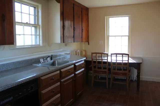 a kitchen with a table chair and window
