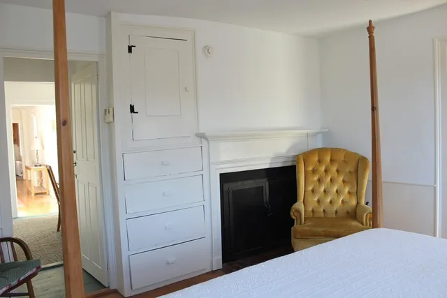 a bedroom with a bed and a mirror