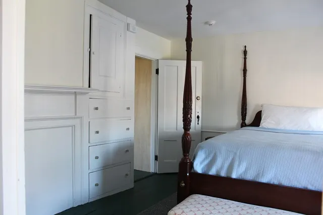 a bedroom with a bed and a closet