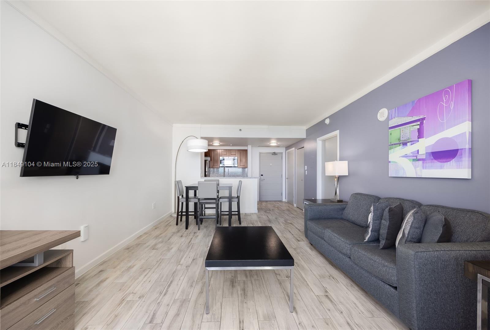 2889 McFarlane Road, Unit 1014 Coconut Grove, FL 33133 - Photo 5 of 15 a living room with furniture and a flat screen tv