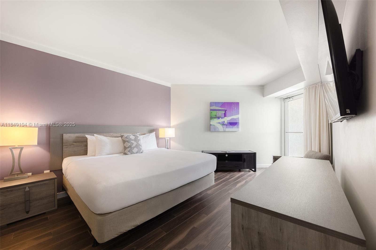 2889 McFarlane Road, Unit 1014 Coconut Grove, FL 33133 - Photo 9 of 15 a bedroom with a bed and a flat screen tv