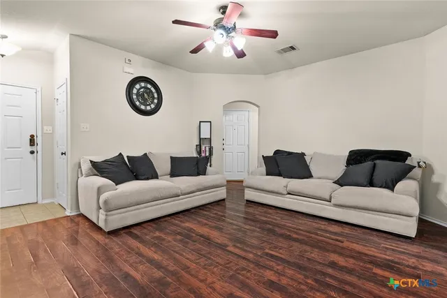 a living room with furniture and a clock