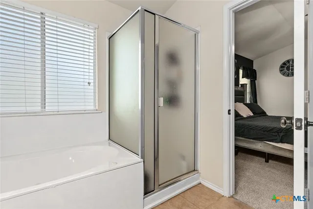 a en suite bathroom with a sink and a mirror