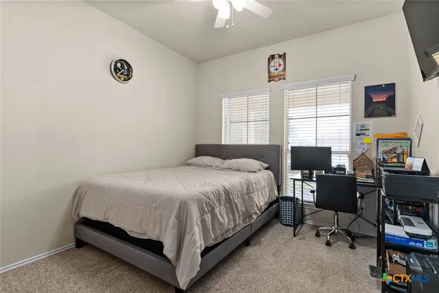 a bedroom with a bed and a desk