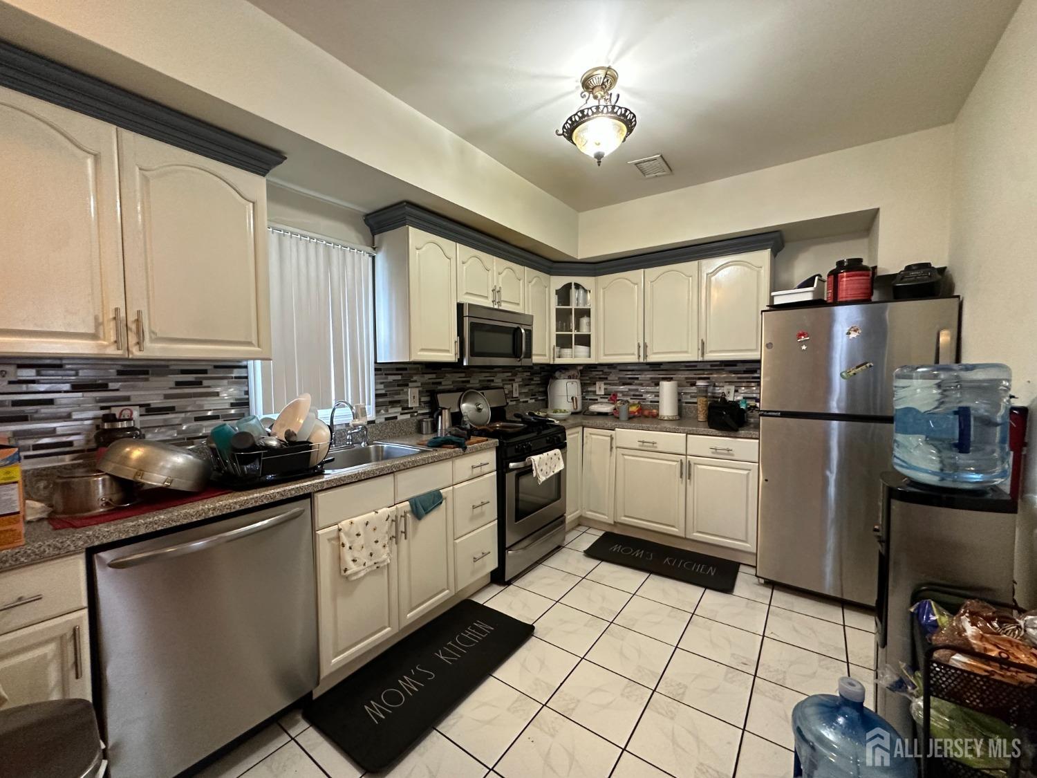 74 State Street Perth Amboy, NJ 08861 - Photo 2 of 9 a kitchen with a sink appliances and cabinets