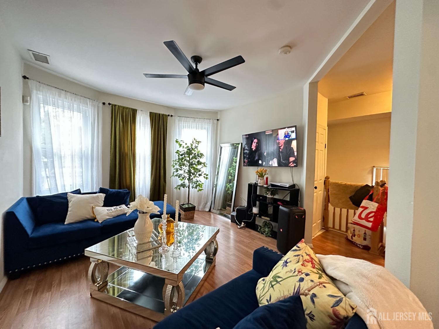 74 State Street Perth Amboy, NJ 08861 - Photo 4 of 9 a living room with furniture and a flat screen tv