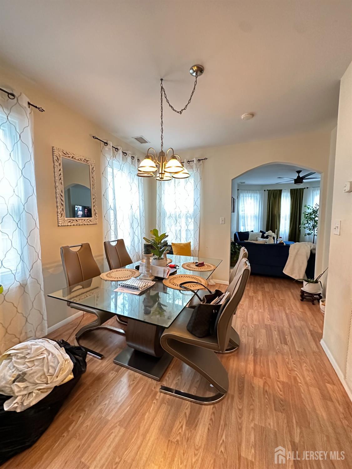74 State Street Perth Amboy, NJ 08861 - Photo 5 of 9 a living room with furniture and a chandelier