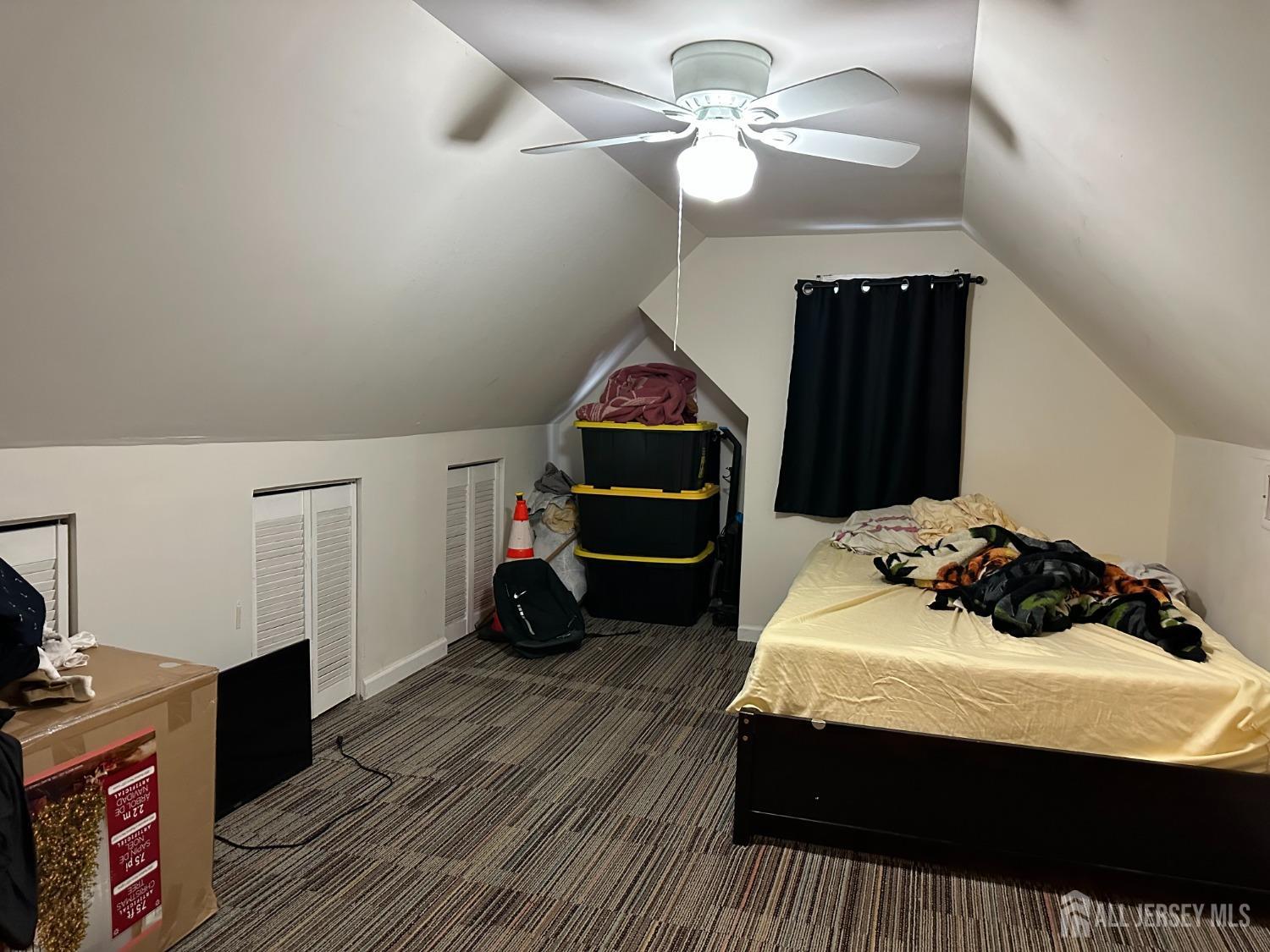 74 State Street Perth Amboy, NJ 08861 - Photo 7 of 9 a bedroom with a bed and a chandelier