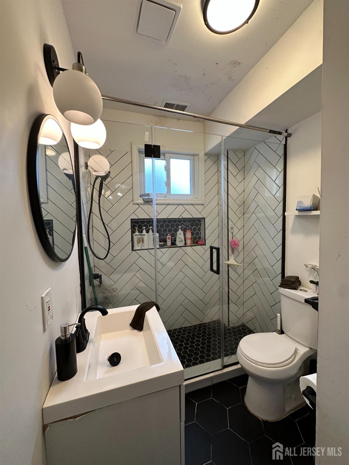 74 State Street Perth Amboy, NJ 08861 - Photo 9 of 9 a bathroom with a toilet sink and mirror