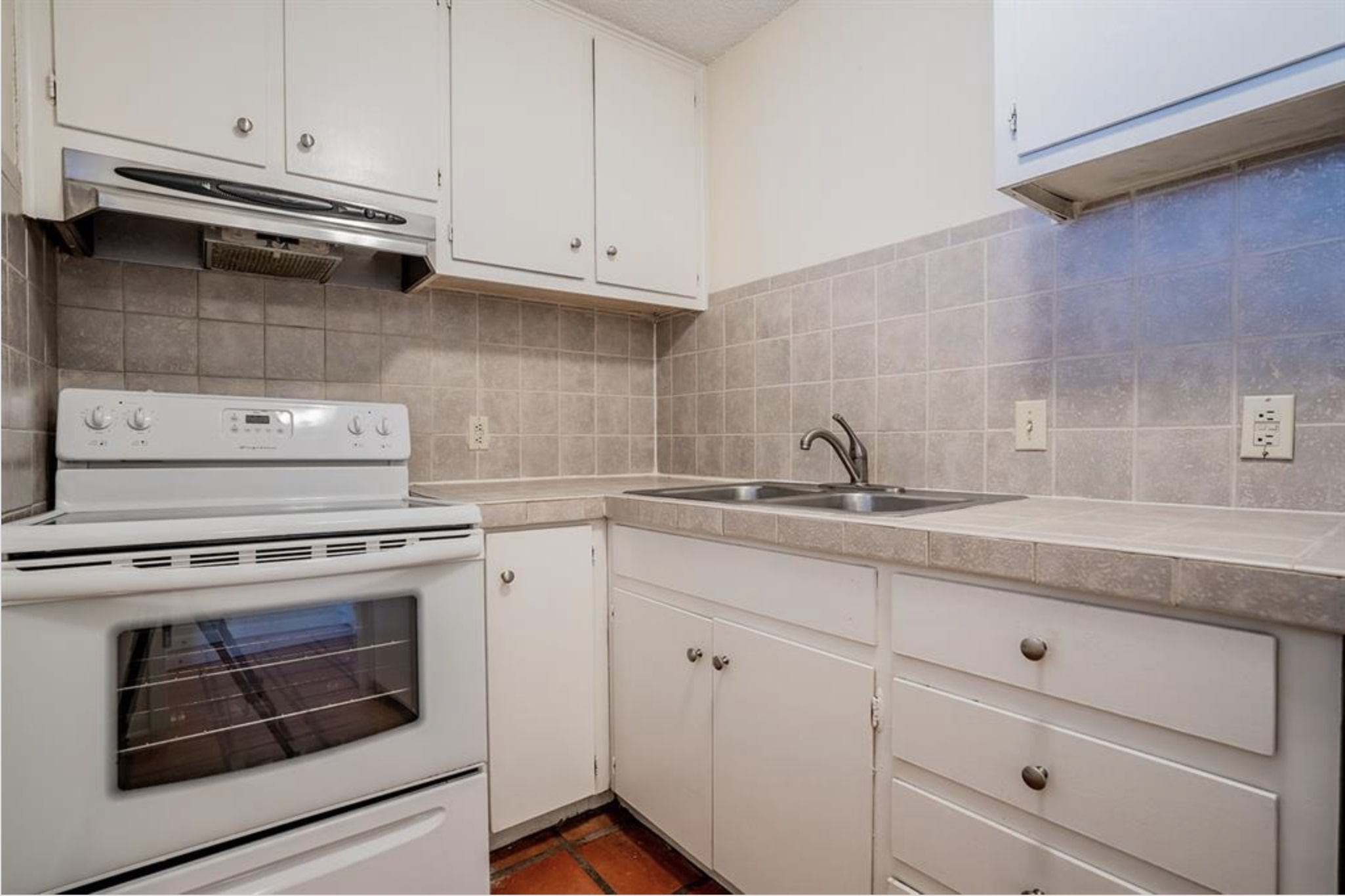 110 East 37th Street, Unit 111 Austin, TX 78705 - Photo 4 of 12 a kitchen with granite countertop white cabinets and appliances