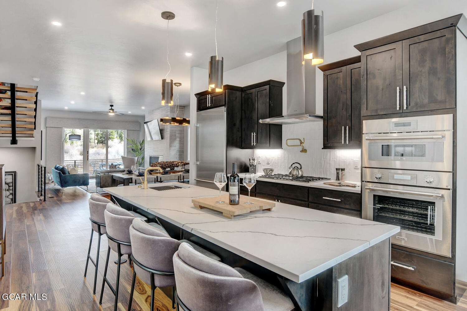 Undisclosed Address Winter Park, CO 80482 - Photo 14 of 52 a kitchen with stainless steel appliances a stove a sink a microwave a dining table and chairs