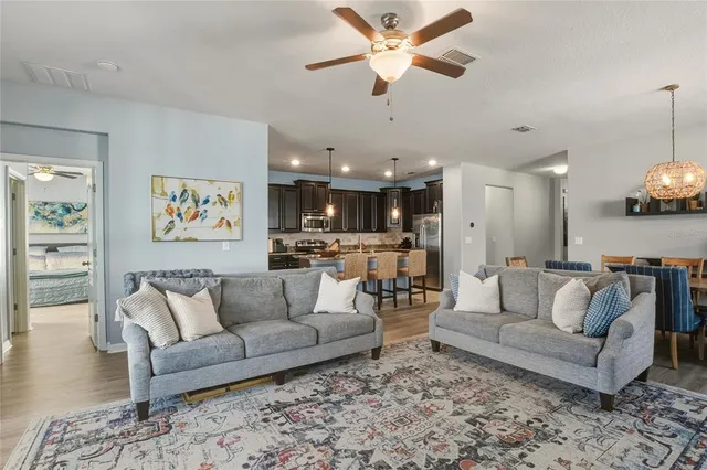 a kitchen with refrigerator a sink and chairs