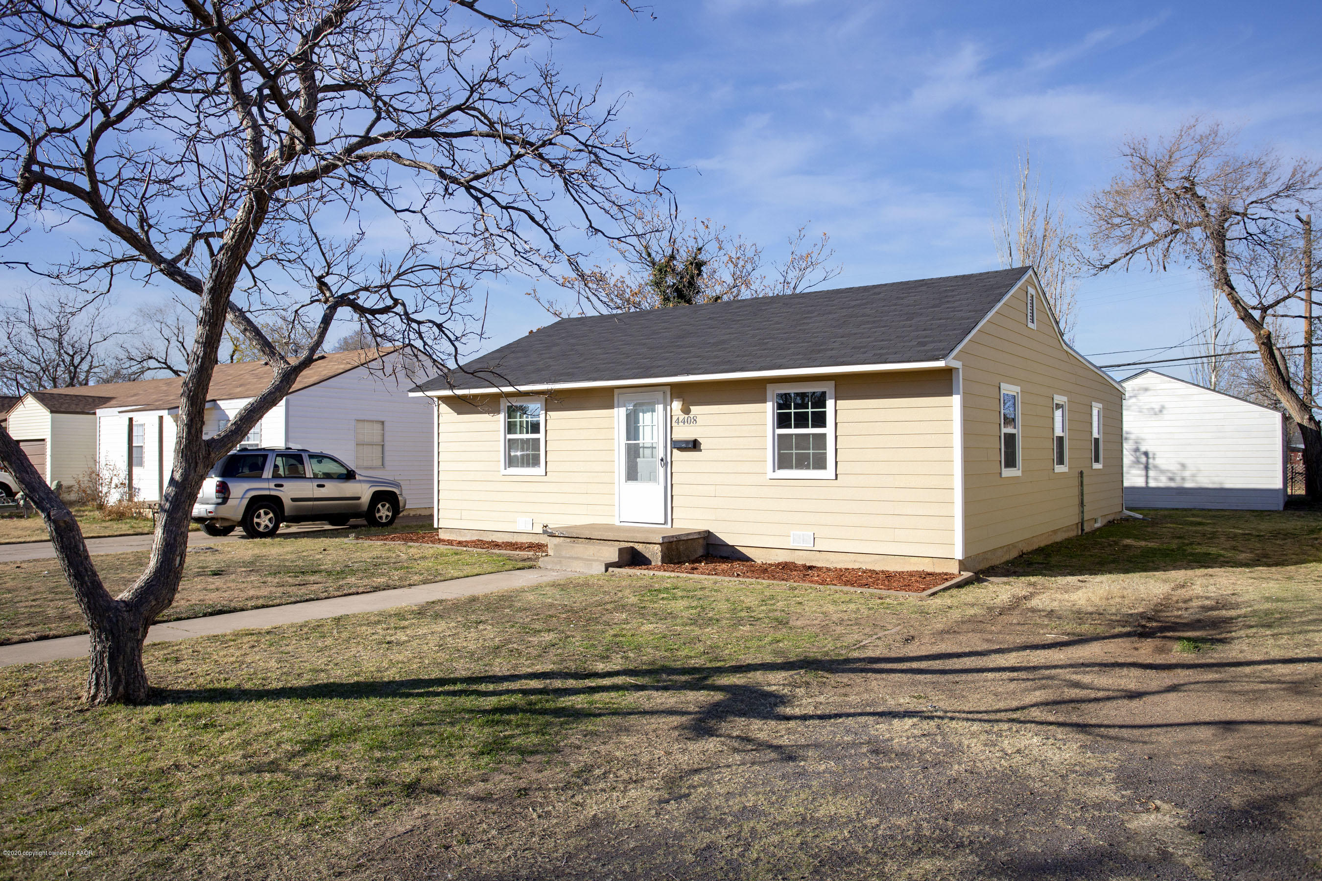 4408 South Travis Street Amarillo, TX 79110 - Photo 1 of 25 a front view of a house with garden