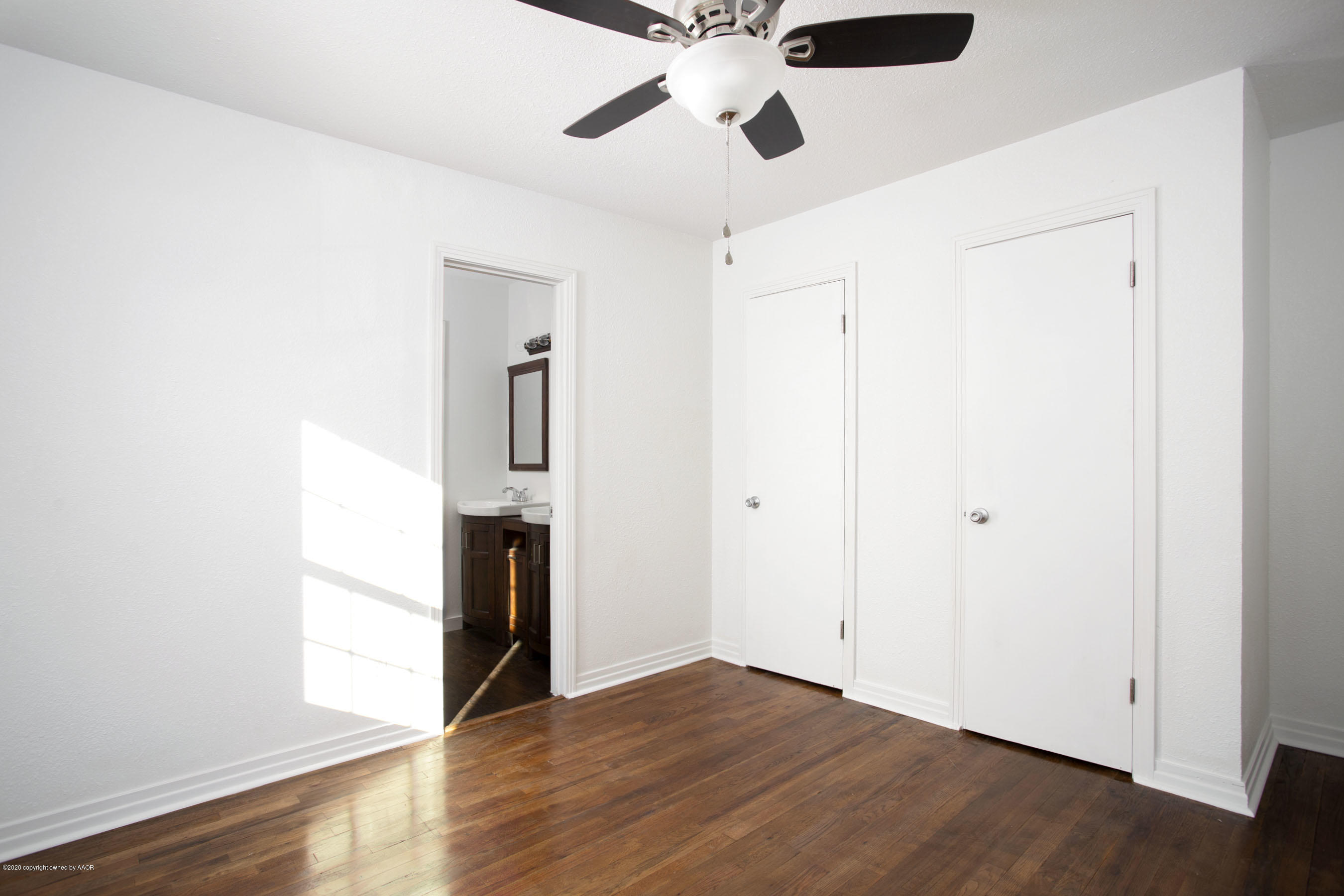4408 South Travis Street Amarillo, TX 79110 - Photo 15 of 25 a view of an empty room with wooden floor