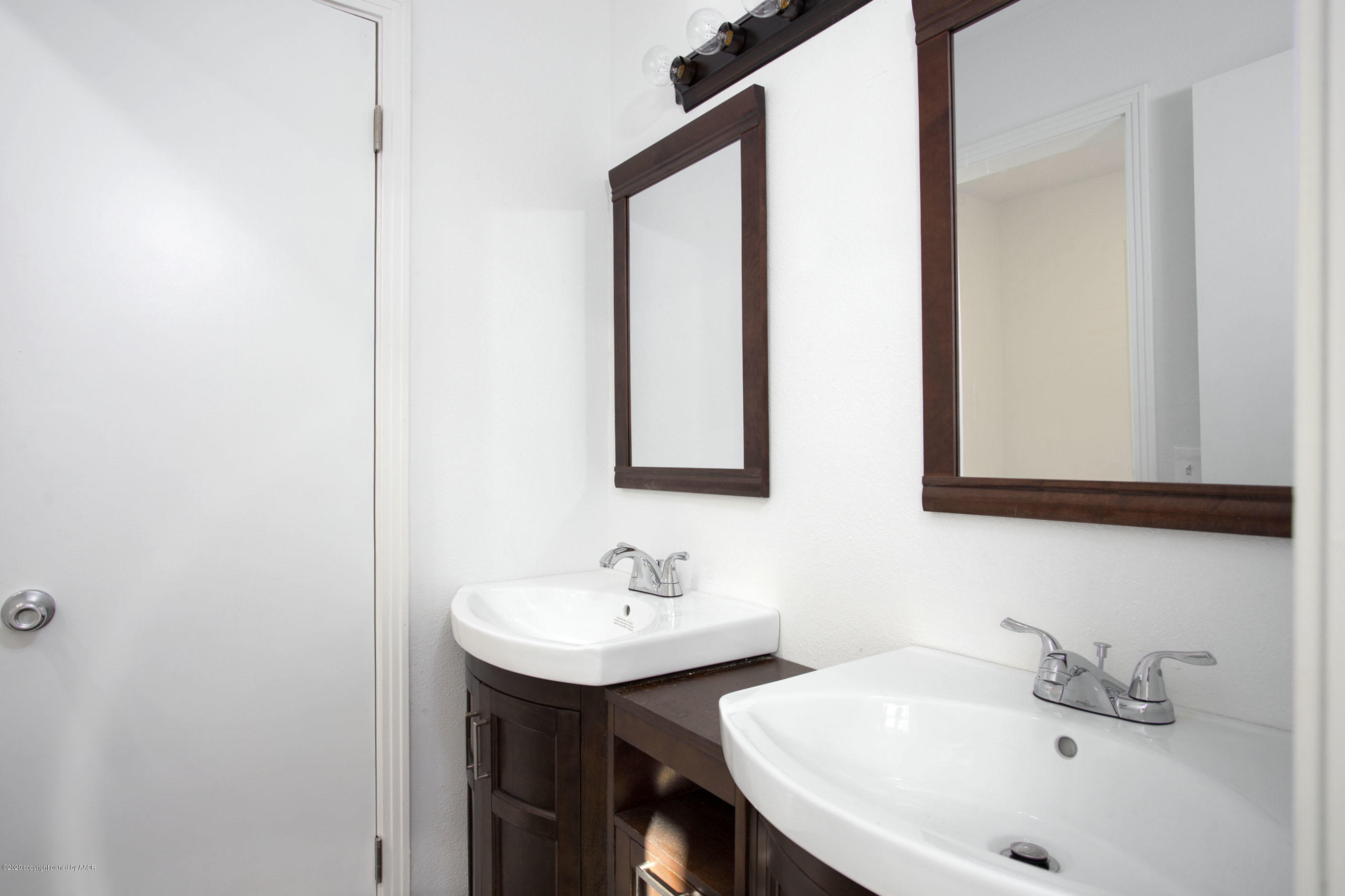 4408 South Travis Street Amarillo, TX 79110 - Photo 16 of 25 a bathroom with a sink and a mirror