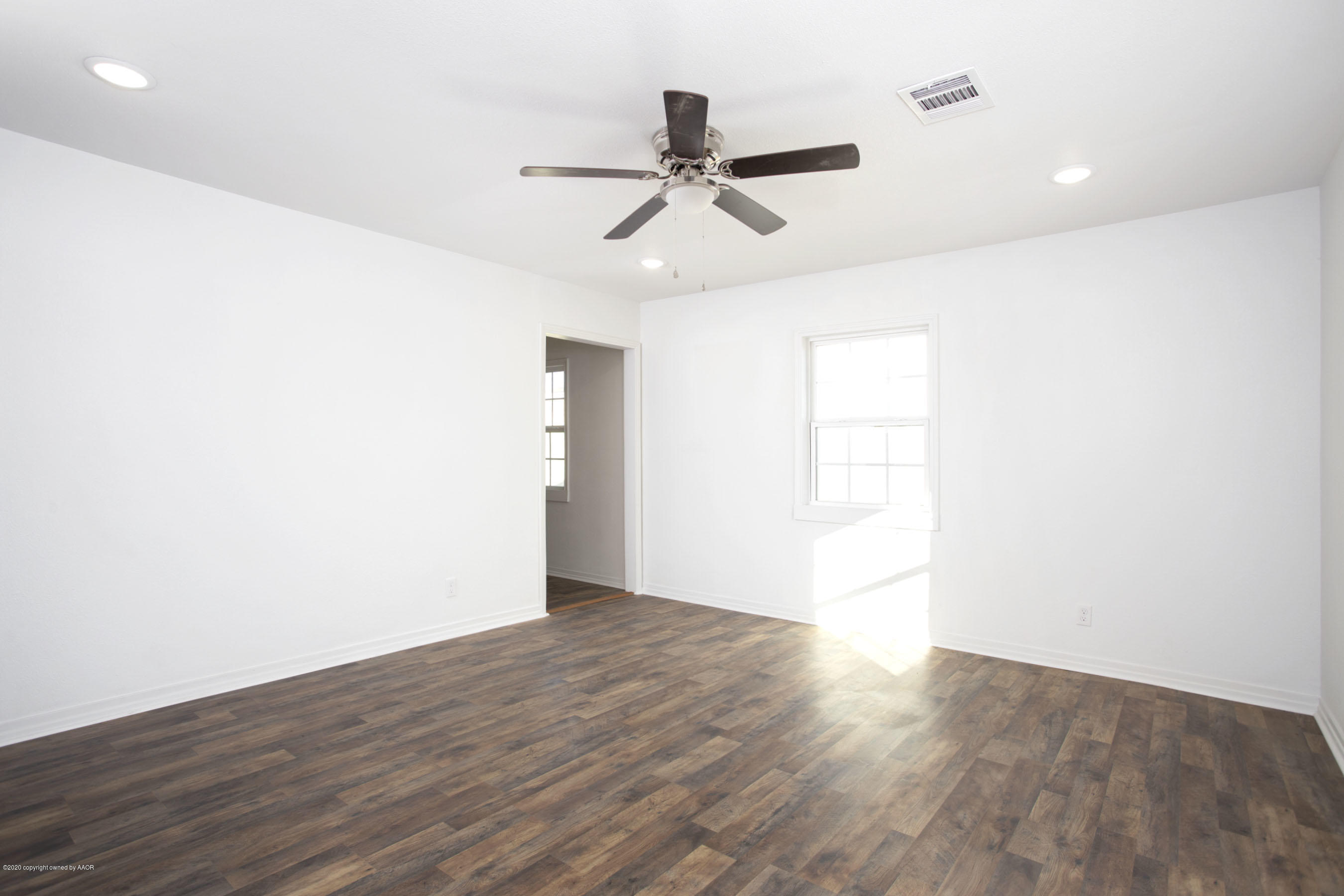 4408 South Travis Street Amarillo, TX 79110 - Photo 18 of 25 a view of empty room with wooden floor