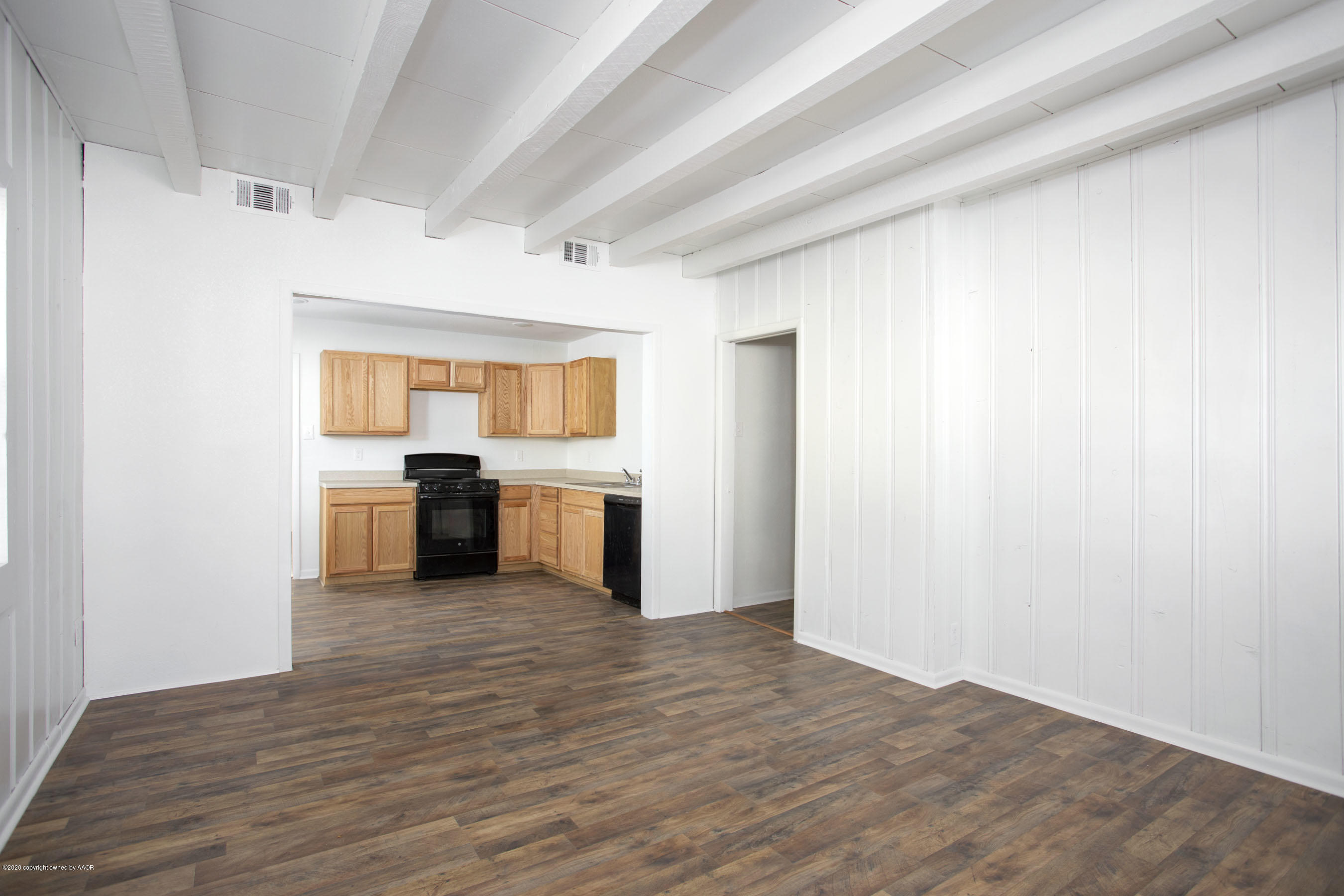 4408 South Travis Street Amarillo, TX 79110 - Photo 4 of 25 a view of a kitchen with wooden floor electronic appliances and window