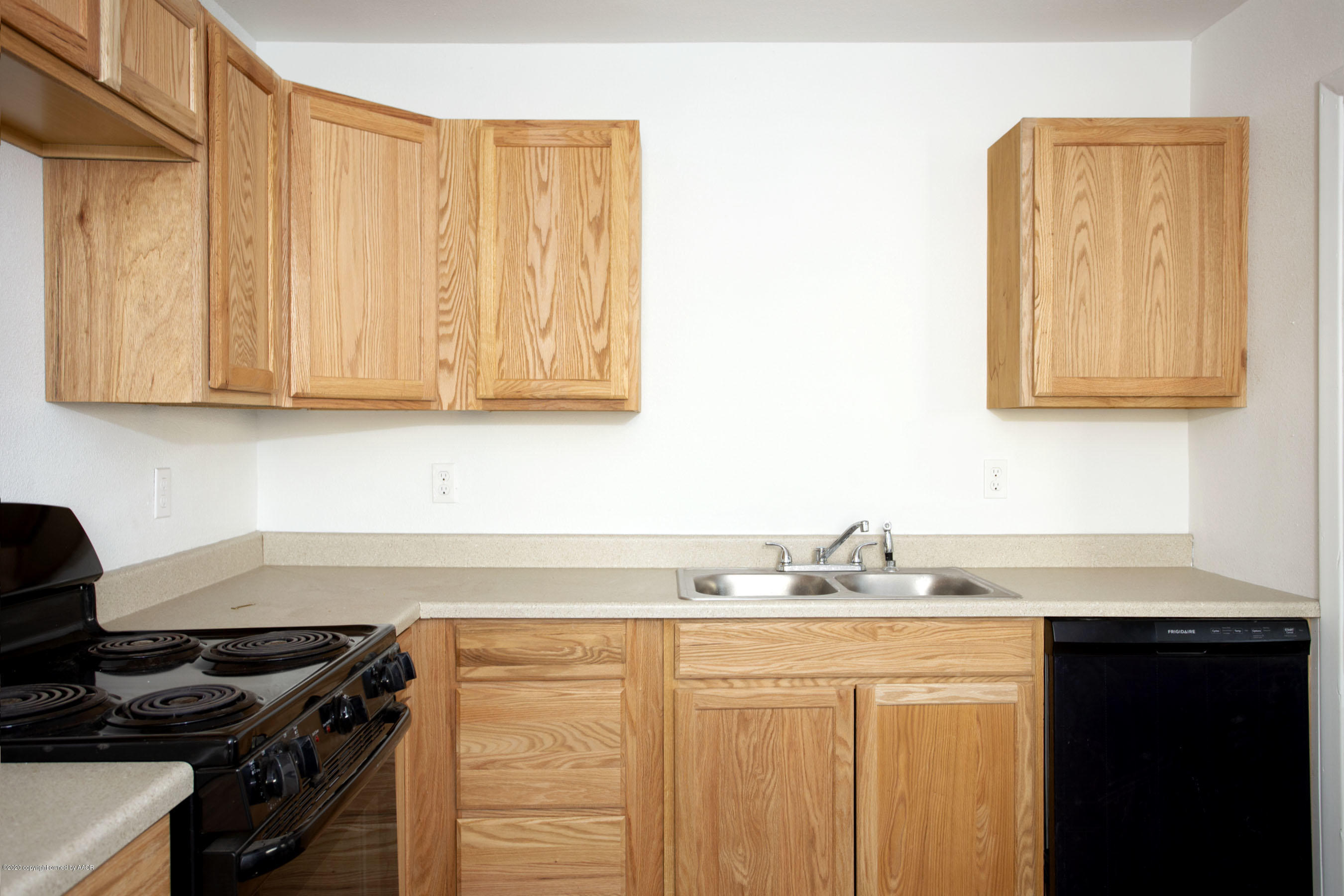 4408 South Travis Street Amarillo, TX 79110 - Photo 6 of 25 a kitchen with stainless steel appliances granite countertop a sink and a stove