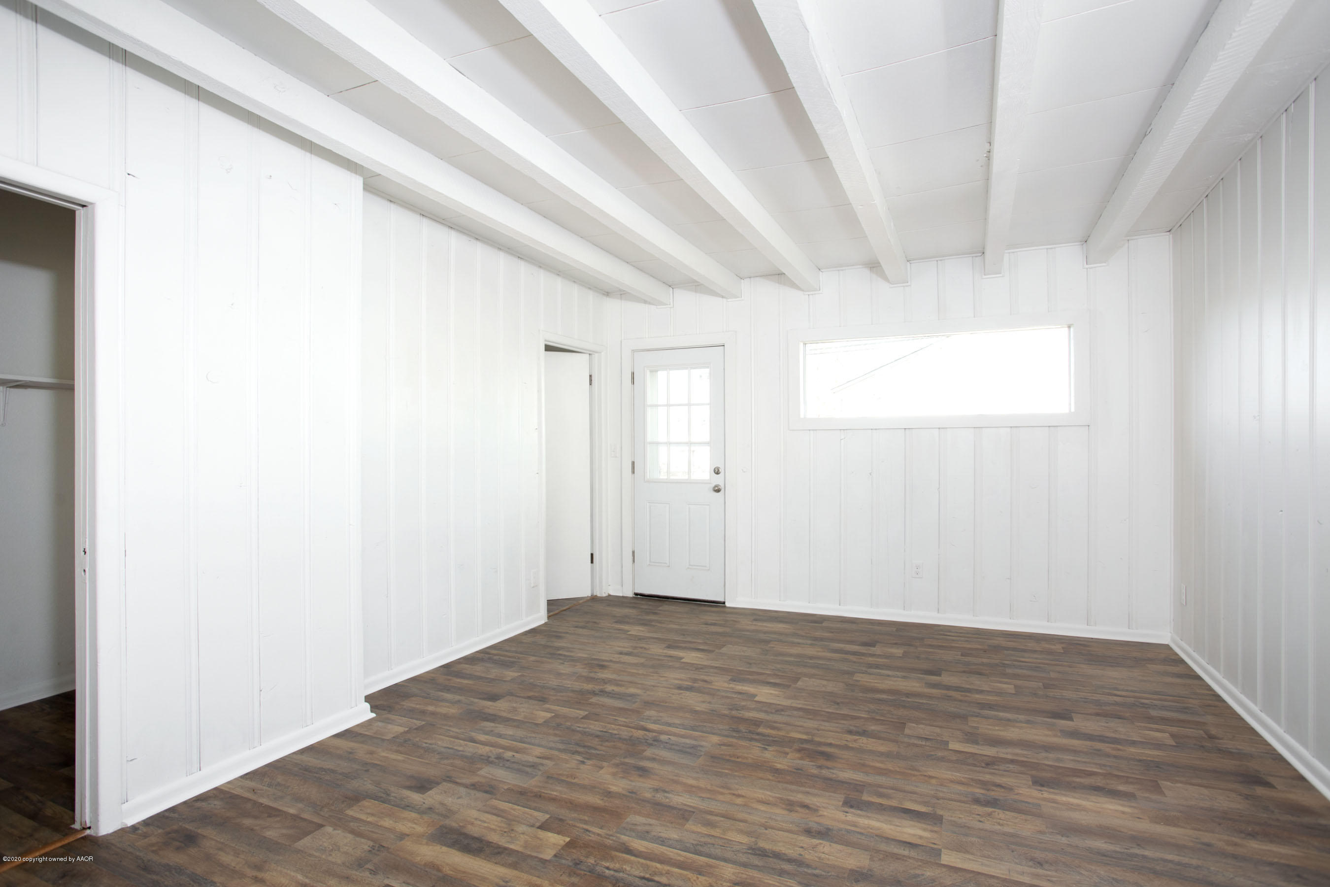 4408 South Travis Street Amarillo, TX 79110 - Photo 8 of 25 a view of an empty room with wooden floor