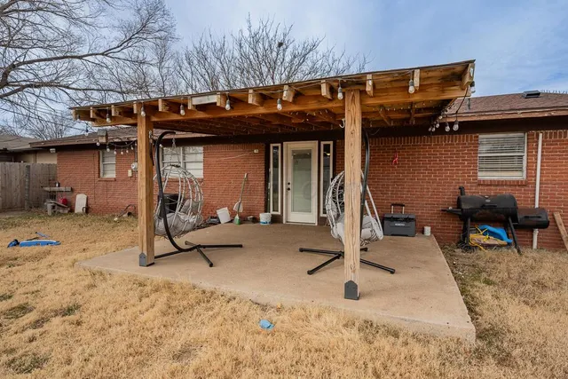 a view of a patio with a table and chairs