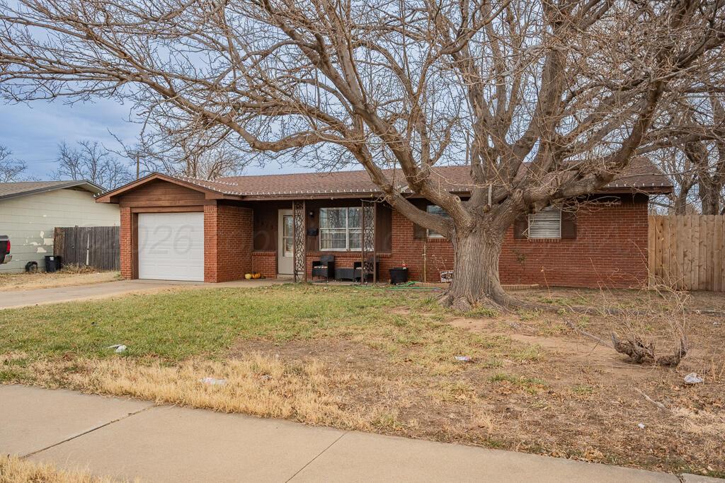 4613 South Bryan Street Amarillo, TX 79110 - Photo 3 of 16 a front view of a house with a yard and garage