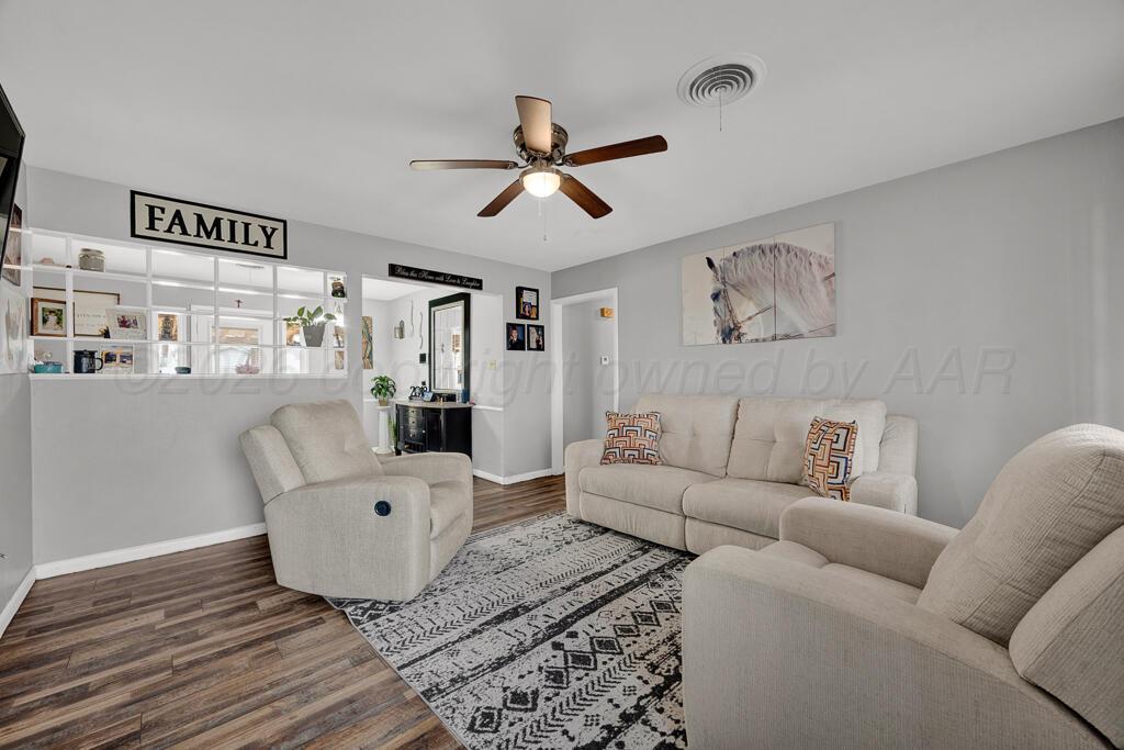 4613 South Bryan Street Amarillo, TX 79110 - Photo 4 of 16 a living room with furniture and a wooden floor