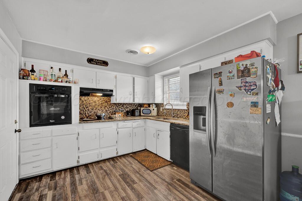 4613 South Bryan Street Amarillo, TX 79110 - Photo 6 of 16 a kitchen with white cabinets and refrigerator