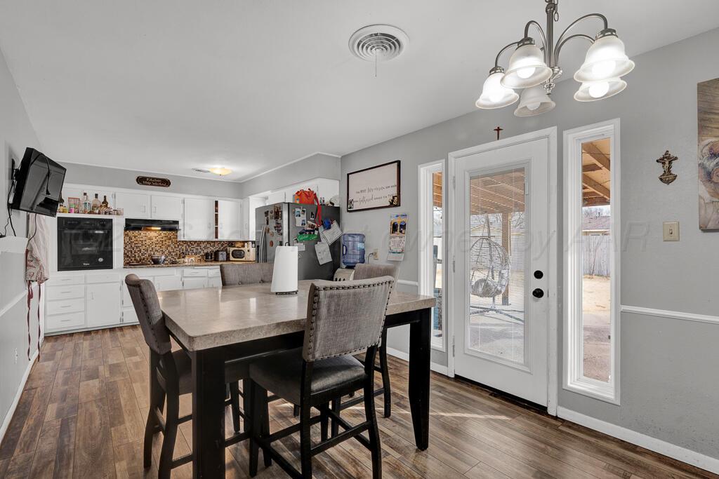 4613 South Bryan Street Amarillo, TX 79110 - Photo 7 of 16 a view of a dining room with furniture and wooden floor