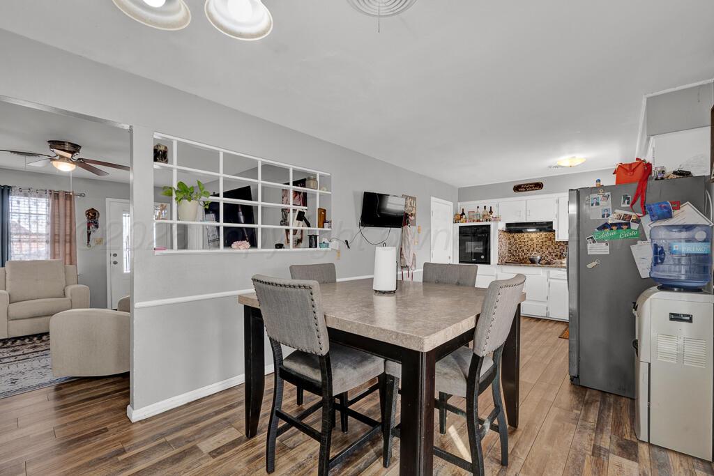 4613 South Bryan Street Amarillo, TX 79110 - Photo 8 of 16 a view of a dining room with furniture and wooden floor