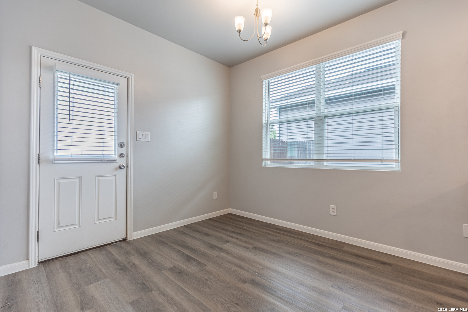 3923 Ivy Path St. Hedwig, TX 78152 - Photo 11 of 32 a view of an empty room with wooden floor and a window