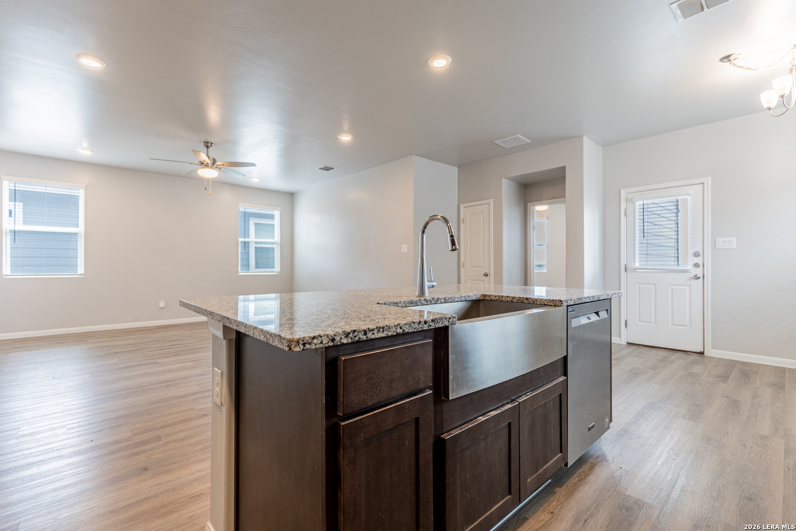 3923 Ivy Path St. Hedwig, TX 78152 - Photo 13 of 32 a kitchen with stainless steel appliances granite countertop a sink and wooden floor