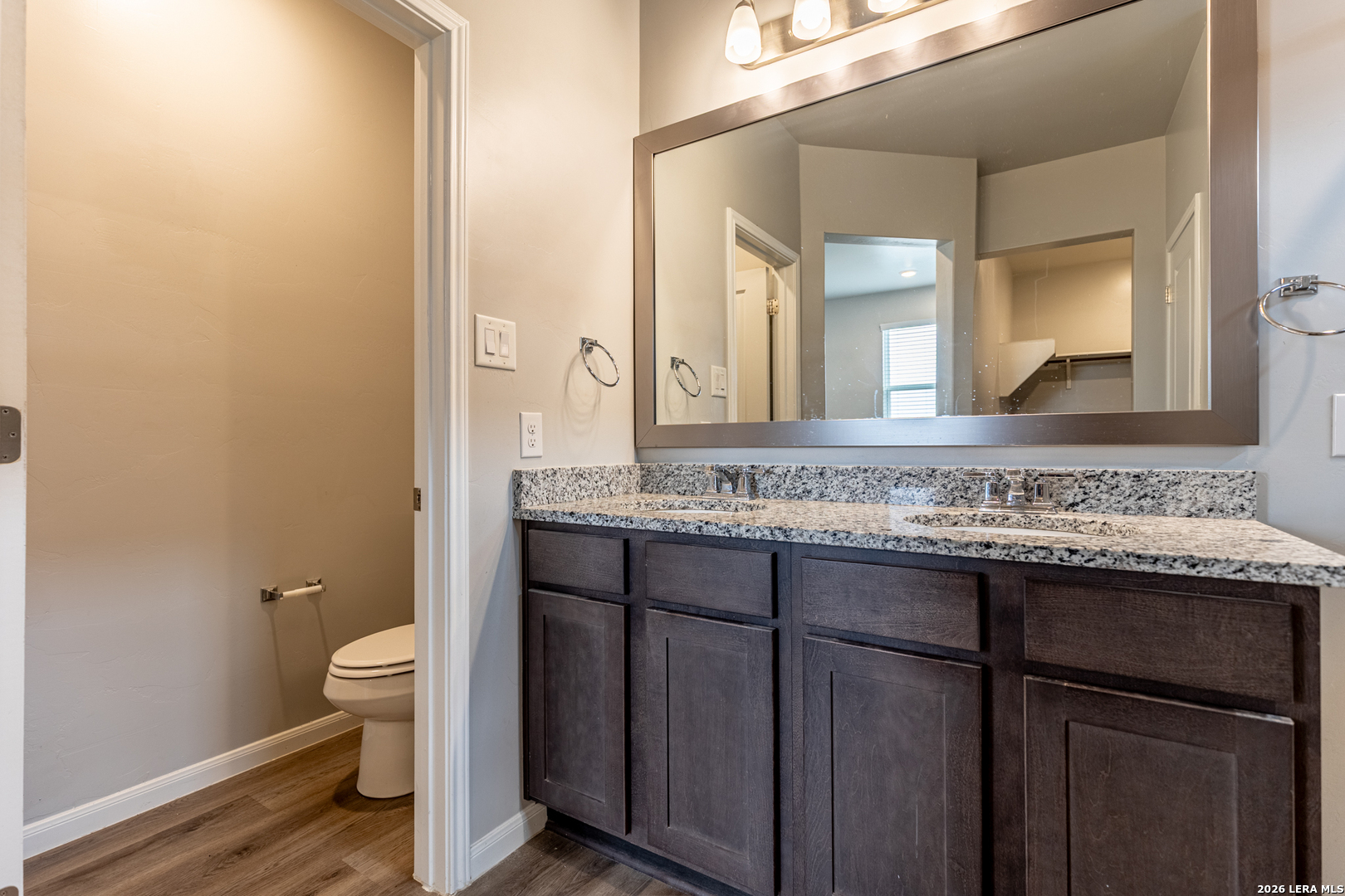 3923 Ivy Path St. Hedwig, TX 78152 - Photo 23 of 32 a bathroom with a granite countertop sink and a mirror