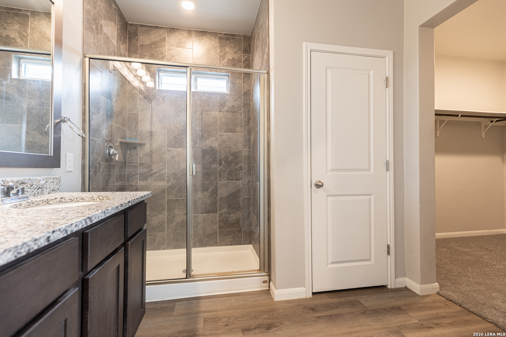 3923 Ivy Path St. Hedwig, TX 78152 - Photo 25 of 32 a bathroom with a granite countertop sink and shower
