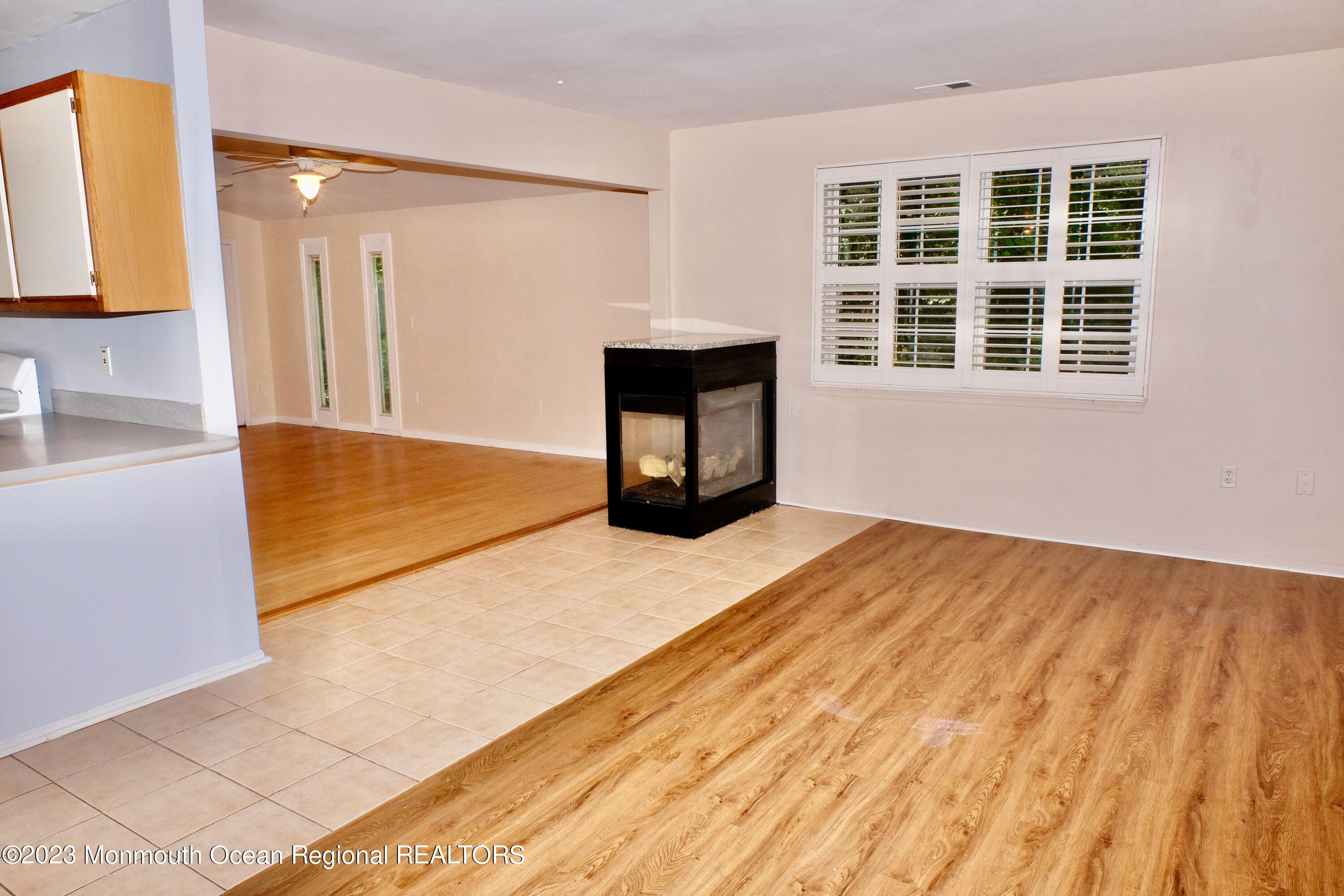 10 Commons Drive Neptune Township, NJ 07753 - Photo 4 of 21 a view of an empty room with a fireplace and a window