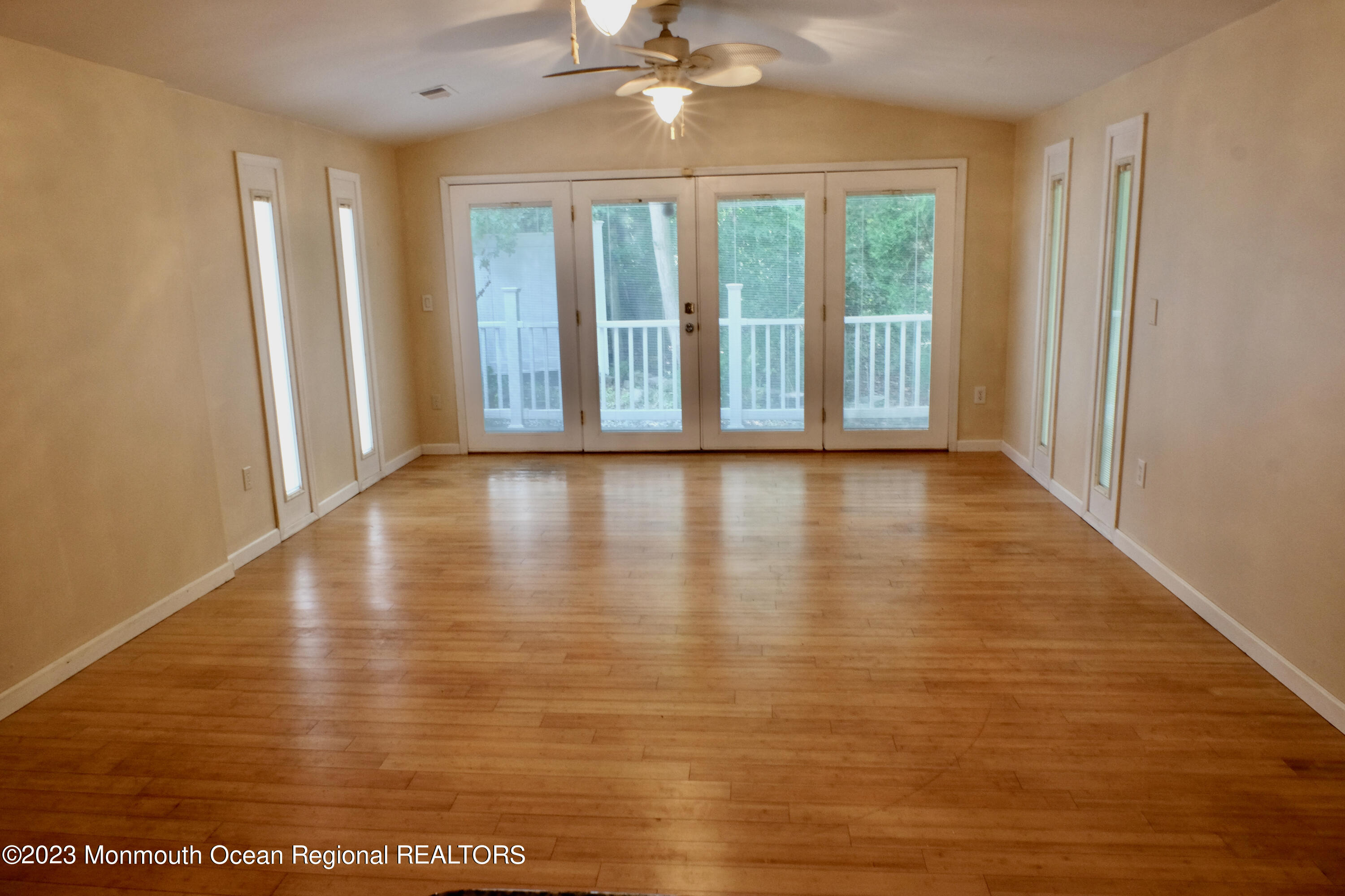 10 Commons Drive Neptune Township, NJ 07753 - Photo 10 of 21 a view of an empty room with wooden floor and a window