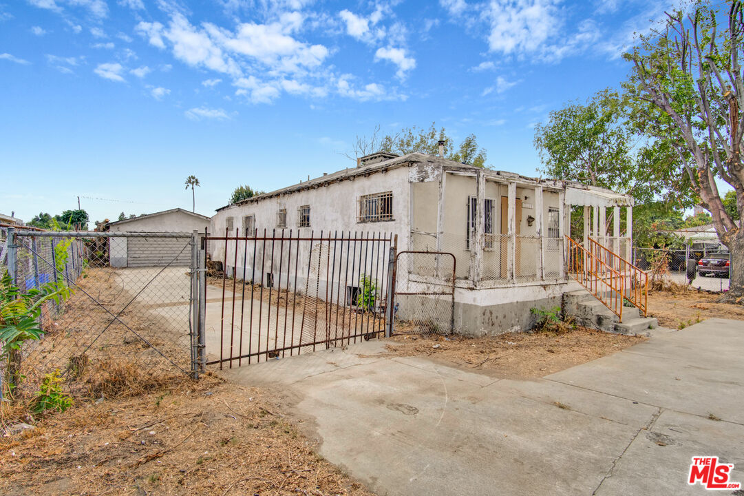 2028 East 126th Street Compton, CA 90222 - Photo 13 of 33 a view of a white house with wooden fence