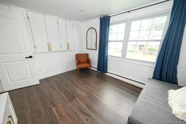 a view of room with window and wooden floor