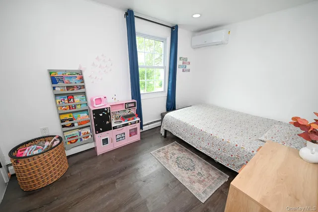 a bedroom with furniture and a wooden floor