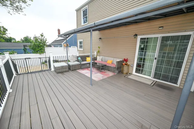 a view of a house with backyard and deck