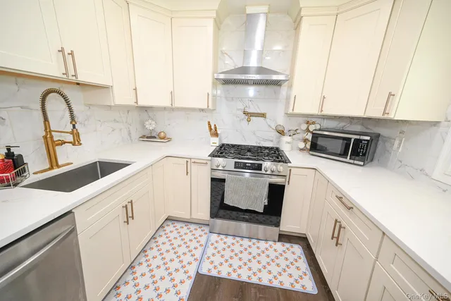 a kitchen with a sink stove and cabinets