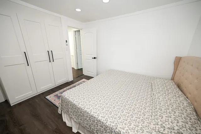 a bedroom with a bed and cabinets