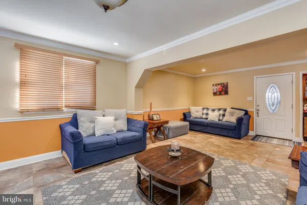 a living room with furniture a rug and a window