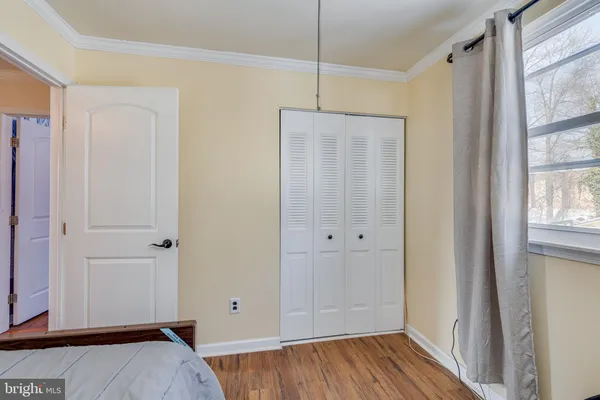 a view of bedroom with window and hardwood floor