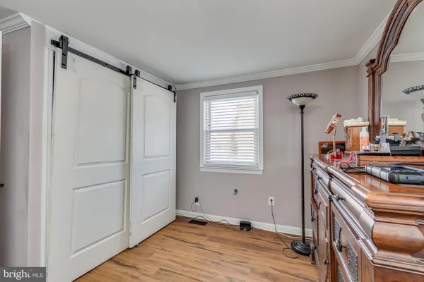 a very nice looking room with wooden floor and a window
