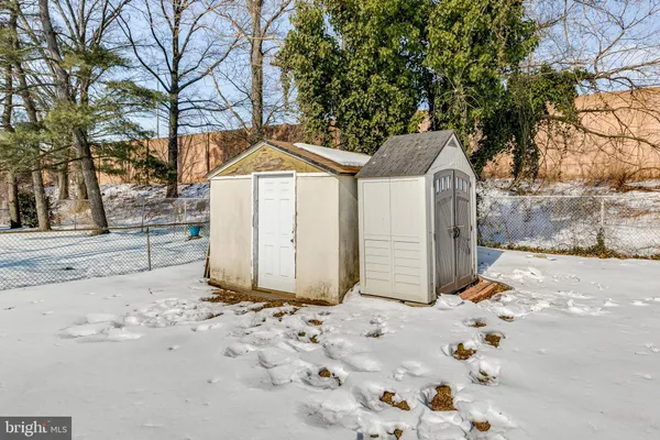 a front view of a house with a yard covered in snow